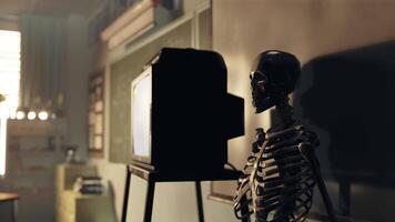 A skeleton sitting in front of a tv in a room video