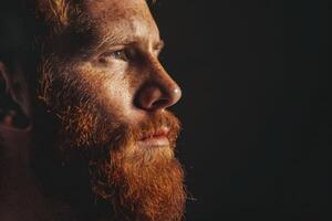 AI generated Pensive red bearded man studio portrait on dark background photo