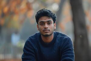 AI generated Young Indian man in dark blue sweater. photo