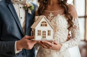 Newlyweds with house model photo