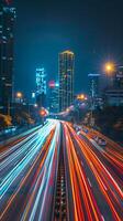 Streaks of moving car lights against the backdrop of city lights at night photo