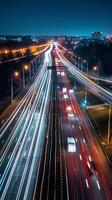 Streaks of moving car lights against the backdrop of city lights at night photo