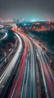 Streaks of moving car lights against the backdrop of city lights at night photo