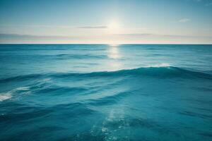 a beautiful sunset over the ocean with waves photo