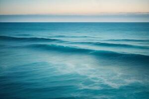 a beautiful blue ocean with waves and clouds photo