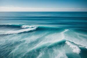 a beautiful blue ocean with waves and clouds photo