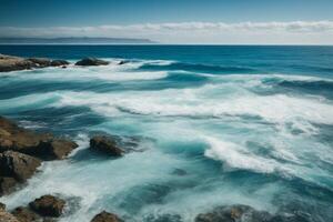 a beautiful blue ocean with waves and clouds photo