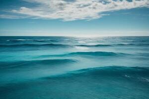 a beautiful blue ocean with waves and clouds photo