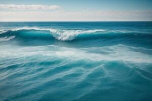 a beautiful blue ocean with waves and clouds photo