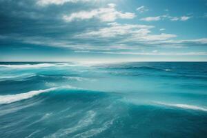 a beautiful blue ocean with waves and clouds photo