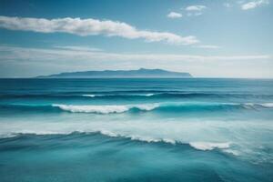 a beautiful blue ocean with waves and clouds photo