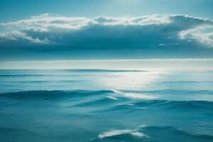 blue ocean with mountains and clouds photo