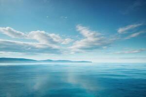 blue ocean with mountains and clouds photo