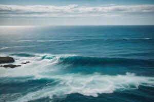 blue ocean with mountains and clouds photo