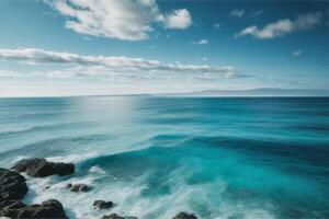 blue ocean with mountains and clouds photo