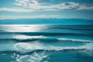 blue ocean with mountains and clouds photo