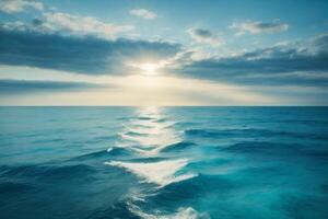 blue ocean with mountains and clouds photo