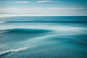 blue ocean with mountains and clouds photo