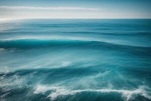 blue ocean with mountains and clouds photo