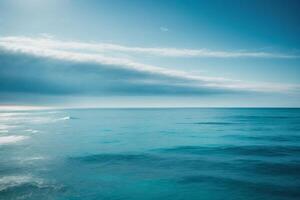 blue ocean with mountains and clouds photo