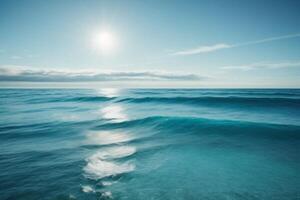 blue ocean with clouds and sun in the sky photo