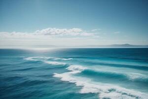 blue ocean with clouds and sun in the sky photo