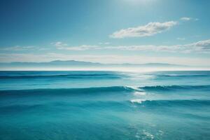 blue ocean with clouds and sun in the sky photo