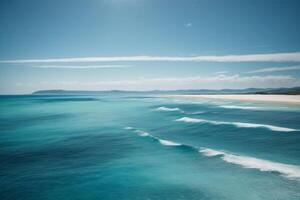 a beautiful beach with waves and blue sky photo