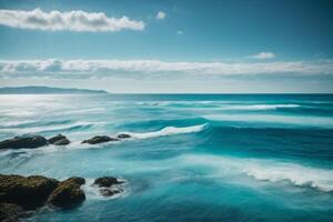 blue ocean with clouds and sun in the sky photo