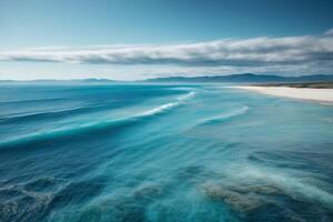 a beautiful beach with waves and blue sky photo