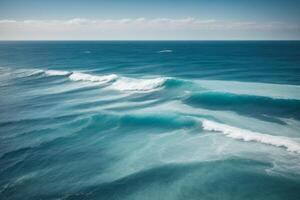 a beautiful beach with waves and blue sky photo