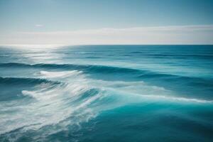 a beautiful beach with waves and blue sky photo