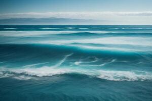 a beautiful beach with waves and blue sky photo