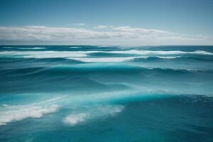 a beautiful beach with waves and blue sky photo