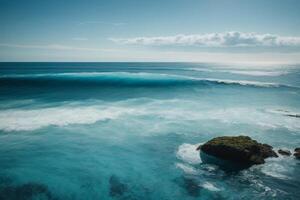 a beautiful beach with waves and blue sky photo