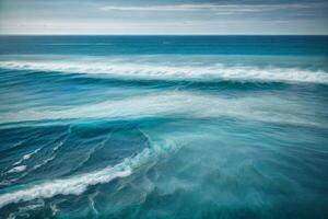 blue ocean waves and sun rays in the ocean photo