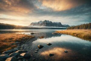 a lake surrounded by trees and grass at sunrise photo