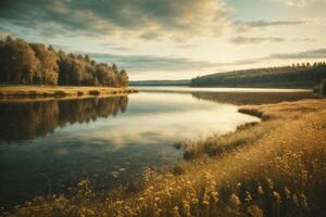 a lake surrounded by trees and grass at sunrise photo