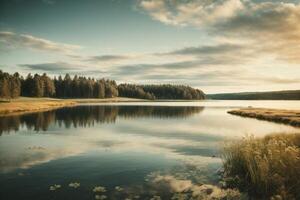 a lake with rocks and trees at sunset photo