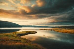 a lake surrounded by trees and grass under a cloudy sky photo