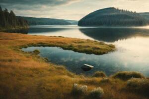 a mountain lake surrounded by grass and trees photo