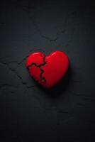 broken heart on black background with red hearts photo