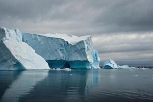 icebergs floating in the water at sunset photo