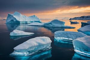 icebergs float in the water at sunset photo