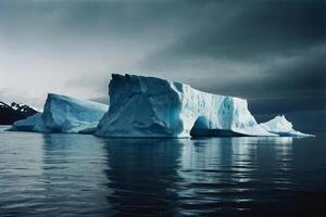 icebergs float in the water at sunset photo