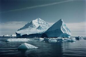 icebergs floating in the water at sunset photo