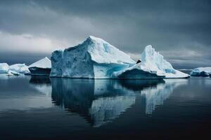 icebergs in the water with a cloudy sky photo