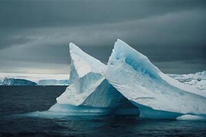 icebergs in the water with a cloudy sky photo