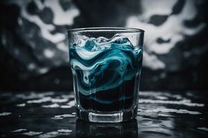 a glass of blue liquid with a black background photo