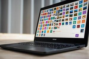 a laptop with many different icons on the screen photo